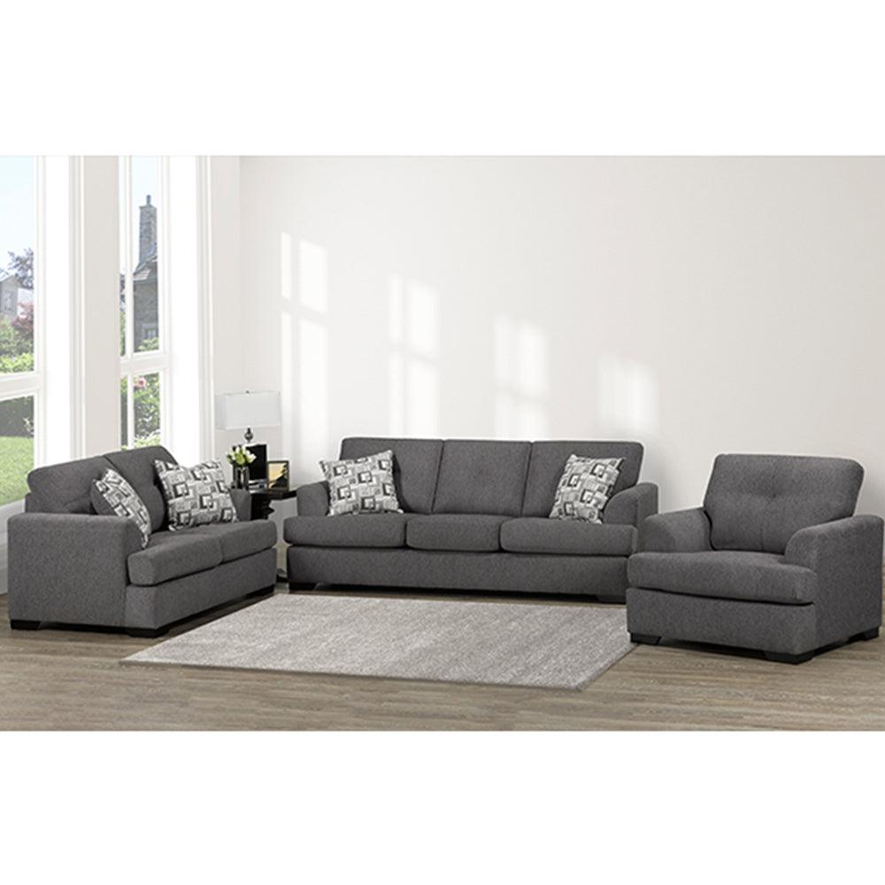 Gray sectional sofa with patterned cushions in a living room setting.