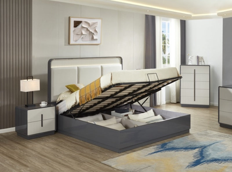 Modern bedroom with a gray upholstered bed, nightstand, and dresser.