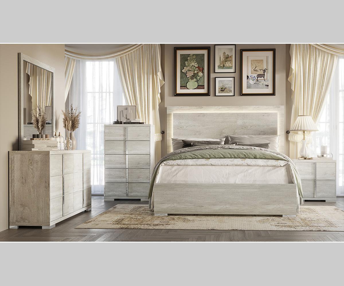 Modern bedroom set with bed, dresser, and nightstands in a well-lit room.