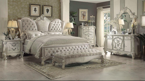 Elegant bedroom with ornate furniture and decorative elements.