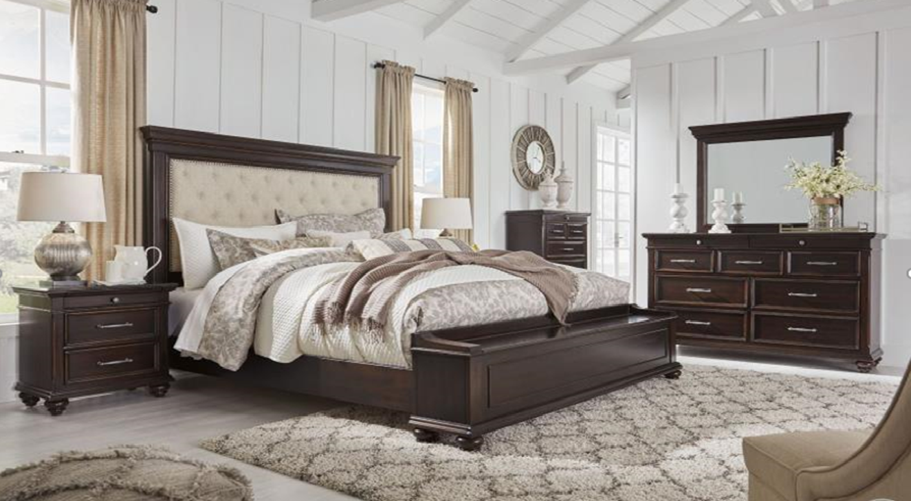 Bedroom set with dark wood furniture including a bed, nightstands, and dresser.