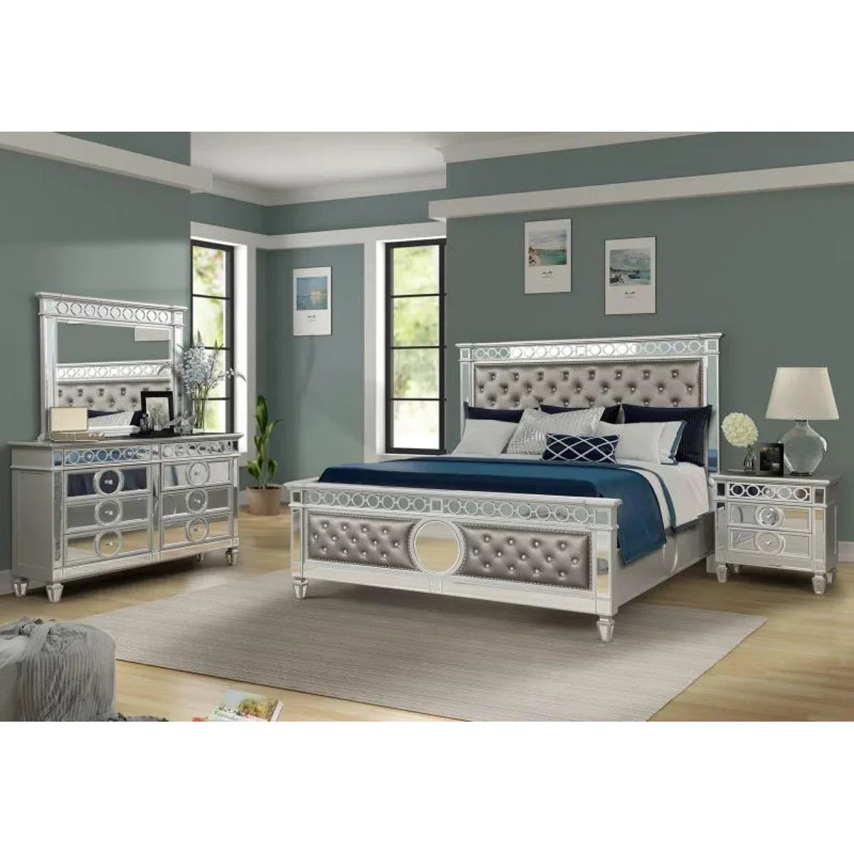 Silver bedroom set with bed, dresser, and nightstands in a room with gray walls and large windows.