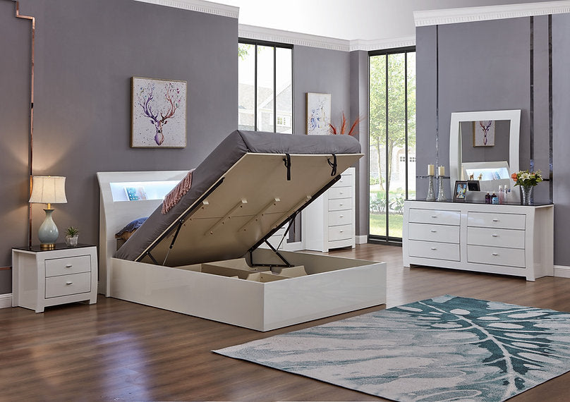 Modern bedroom with a lift-top bed, dresser, and nightstands.