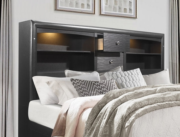 Bedroom with a bed featuring pillows and blankets, and a dark wood headboard with storage.